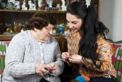 elderly woman and caregiver doing handycraft activity